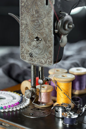 Sewing machine and spools of thread on the table.