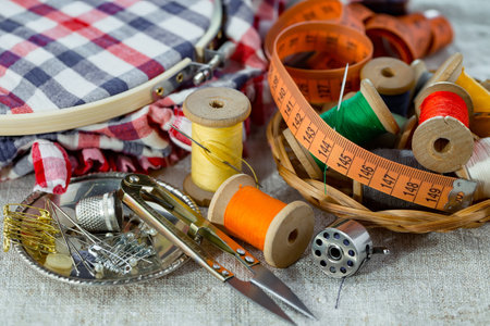 Sewing tools and accessories for needlework on a wooden backgroundの写真素材
