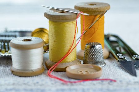 Sewing accessories on the table. Thread, needles, thimble.の写真素材