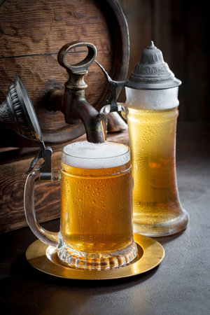 Light beer in a glass on an old background. Selective focusの写真素材