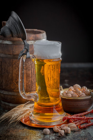 Light beer in a glass on a table in composition with kitchen accessoriesの写真素材