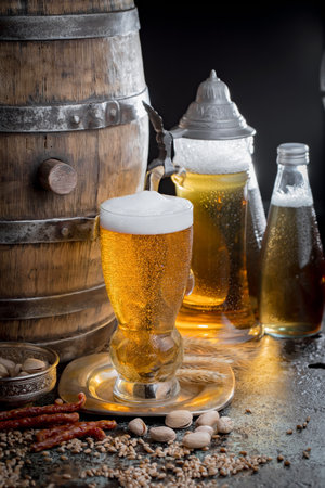 Light beer in a glass on an old background in composition with accessoriesの写真素材