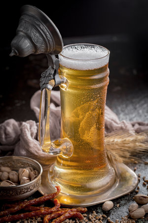Light beer in a glass on an old background. Selective focusの写真素材
