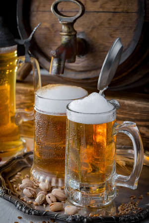 Light beer in a glass, on an old background.の写真素材