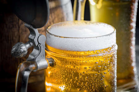 Light beer in a glass, on an old background.の写真素材
