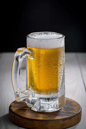 Light beer in a glass, on an old background.の写真素材