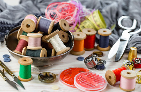 Sewing accessories on the table. Thread, needles, pins, scissors, thread.