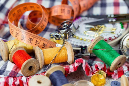 Sewing accessories for needlework. Sewing threads, needles, pins and measuring tapeの写真素材