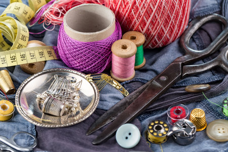 Sewing accessories for needlework. Thread, pins, scissors and measuring tapeの写真素材