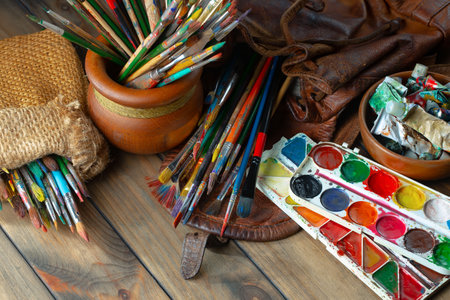 Paintbrushes and brushes on a wooden table in art studioの写真素材