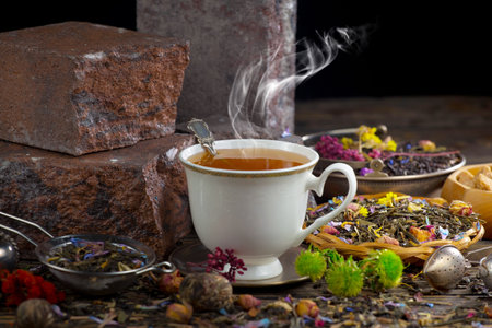 Tea hot drink on old background in composition with accessories on the tableの写真素材