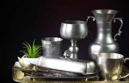 Antique silverware on a dark background. Vintage kitchen utensils.