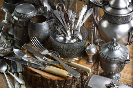 Vintage silverware and utensils on a wooden table.の写真素材