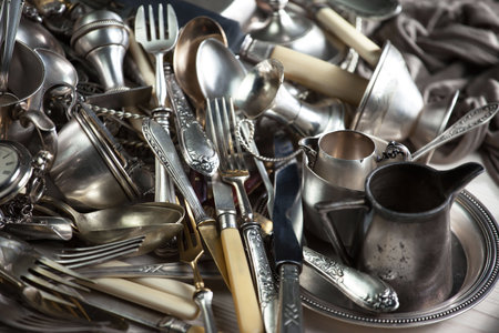 Vintage silverware and utensils on a wooden table.の写真素材