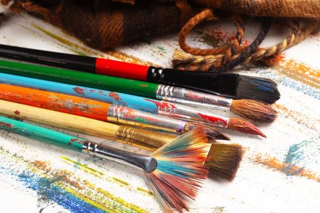 Paint brushes and canvas on a white background, close-up