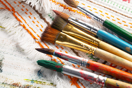 Paint brushes and canvas on a wooden background, close-upの写真素材