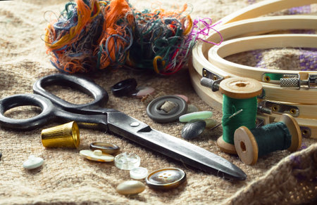 spools of thread, scissors, buttons, thimble and fabric