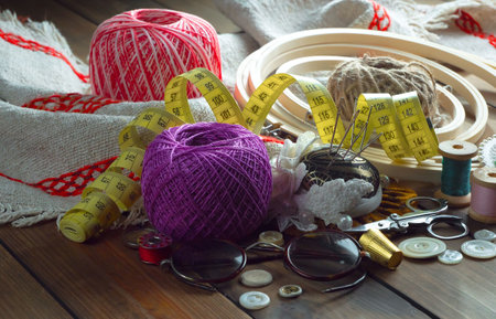 Sewing accessories on a wooden table. Selective focus.