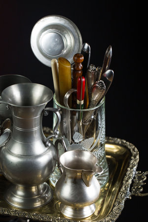 Vintage silverware and utensils on a dark background.の写真素材