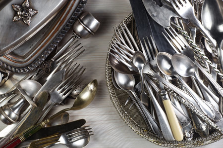 Vintage silverware and cutlery on a wooden table.の写真素材