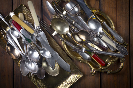 Vintage spoons, forks and knives on a wooden backgroundの写真素材