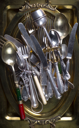 Vintage cutlery on a golden plate. Selective focus.の写真素材