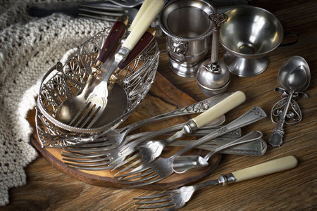 Vintage silverware on a wooden background. Selective focus.の写真素材