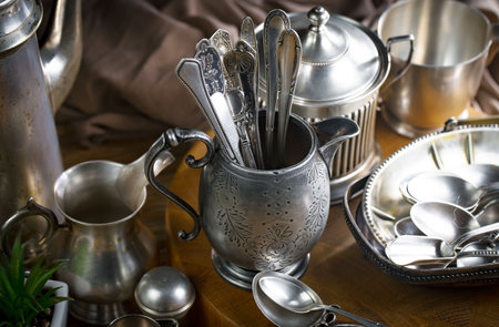 Vintage silverware on a wooden table. Selective focus.の写真素材