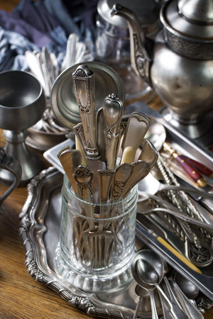 Vintage silverware and utensils in a glass vaseの写真素材