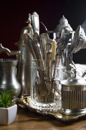 Vintage silverware and utensils on a wooden table.の写真素材