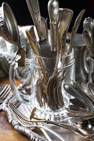 Vintage silverware on a dark background. Selective focus.の写真素材