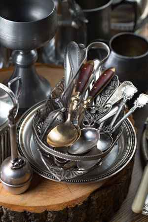 Vintage silverware on a wooden background. Selective focus.の写真素材