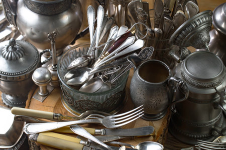 Vintage silverware and utensils on a wooden table.の写真素材