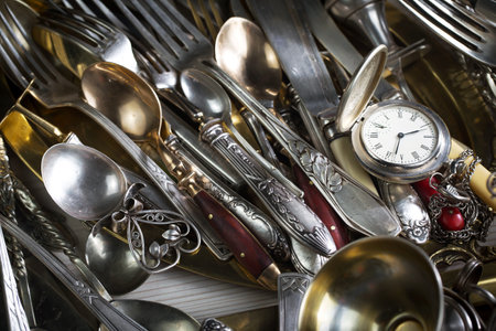 Vintage silverware on a market stall, closeup of photoの写真素材