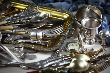 Vintage silverware and cutlery on a wooden table.の写真素材