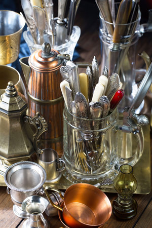 Antique silverware and coffee maker on a wooden table. Selective focus.の写真素材
