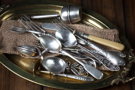 Vintage silverware and napkin on wooden table, closeupの写真素材
