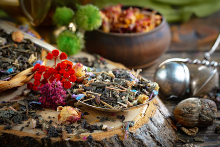 Dry tea leaves and flowers on wooden background. Selective focusの写真素材