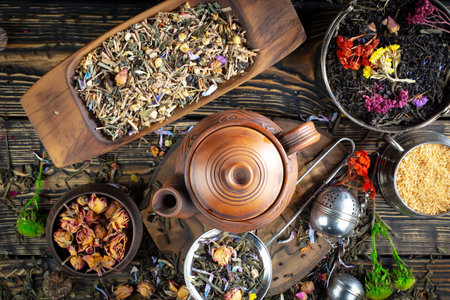 Variety of dry tea leaves and flowers on rustic wooden backgroundの写真素材