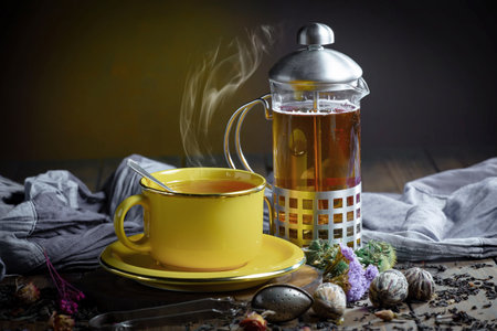 Tea hot drink on old background in composition with accessories on the tableの写真素材