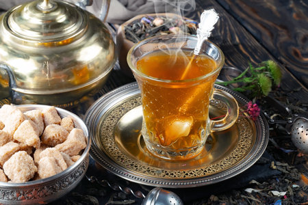 Tea hot drink on old background in composition with accessories on the tableの写真素材