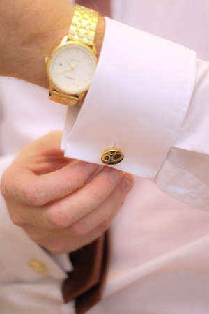 close up of a hand man how wears white shirt and cufflinkの写真素材