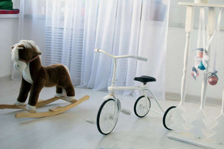 kid's room in white clolor with toys and tricycleの写真素材