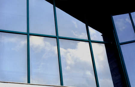 wall glass skyscraper with reflection of the skyの写真素材