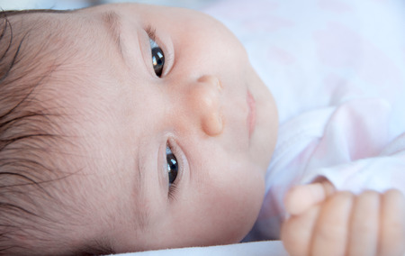 Baby face close-up, selective focus. の写真素材