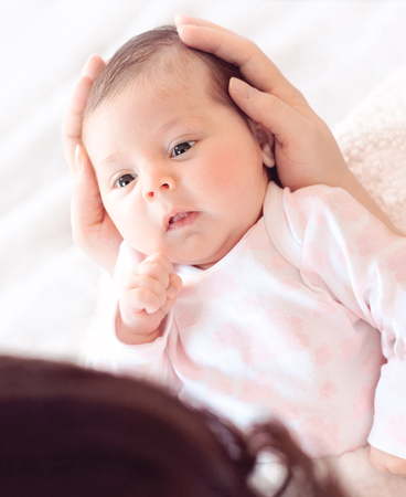  Gently mother hands holding baby . Plump and beautiful newborn stares at her mother.
gentle. の写真素材