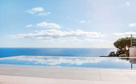 Luxury swimming pool in front of the sea. Swimming pool with beautiful sea and sky view.のeditorial素材