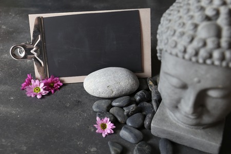 buddha head with stones , flowers and tabularの写真素材