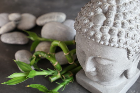 buddha head with stones , bamboo and tabularの写真素材