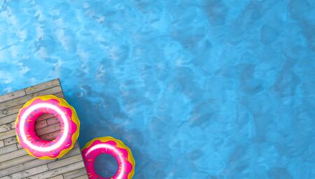 colorful inflatable ring donut toy in swimming pool water,3d renderingの写真素材
